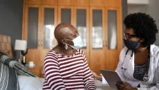 Doctor visits with a patient and discusses diagnosis