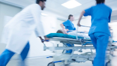 Hospital staff pushing a patient on a gurney
