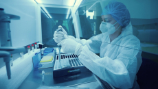 Lab worker in full protective gear