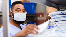 Healthcare worker in mask getting supplies