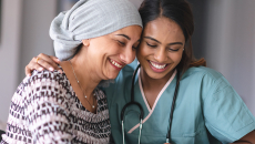 Healthcare worker embracing patient with head wrap