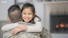 Military serviceperson hugging child