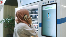 A patient in a teleconsultation with a pharmacist via PharmaSis vending machine