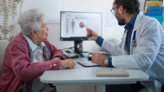 Doctor showing medical data on a screen to a patient