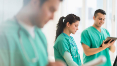 Nurses working with tablets and laptops