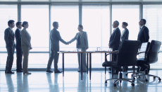 Businesspeople shaking hands in a meeting