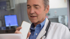 Doctor speaks into a mobile device