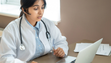 Healthcare professional at laptop