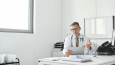 Doctor in an office talk to a tablet