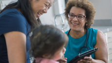 Healthcare worker talking to patient and child