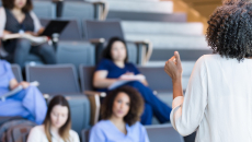 Alt text: A university instructor lecturing college students