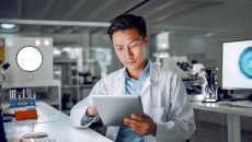 Doctor in lab looking at tablet