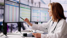 Healthcare worker looking at medical data on screen