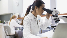 Lab worker using a microscope