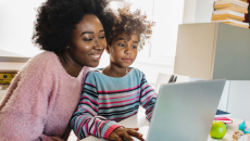 Parent and child using a laptop