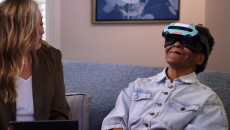 Person using VR headset while another looks on