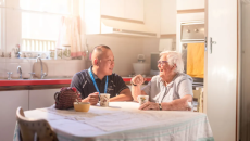 Aged care nurse conversing with a resident