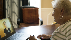 Person speaking to healthcare worker on laptop