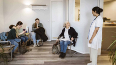 Nurse calls for a patient in a waiting room