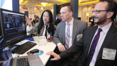 People in suits at a computer screen