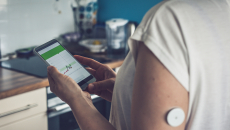Patient checking glucose levels on a phone app