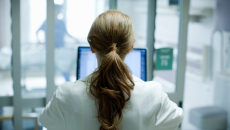 clinician working on a computer