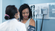 Doctor and patient with blood pressure cuff