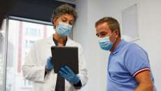 Doctor and patient look at information on a tablet