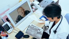 Doctor looks at imaging in a telehealth session with a patient