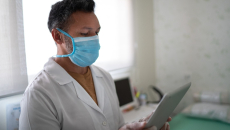 Nurse checks her tablet