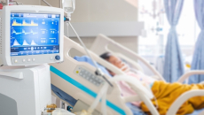 Patient in hospital bed with ventilator