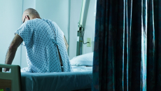Patient sitting on hospital bedside