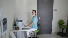 Clinician at keyboard conducting a telehealth appointment