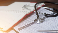 Paper charts and stethoscope