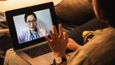 Patient waving at doctor on tablet screen