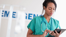 Healthcare worker using a tablet in a hospital