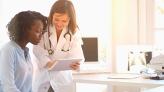 Doctor showing tablet to patient