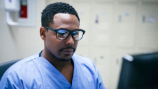 Healthcare worker looking at a computer screen