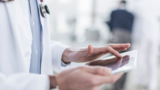 A doctor using a digital tablet