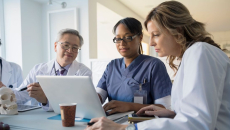 Health professionals using a laptop to collaborate remotely
