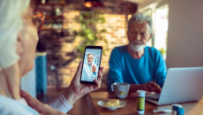 A senior patient in a video consultation with a doctor via mobile phone