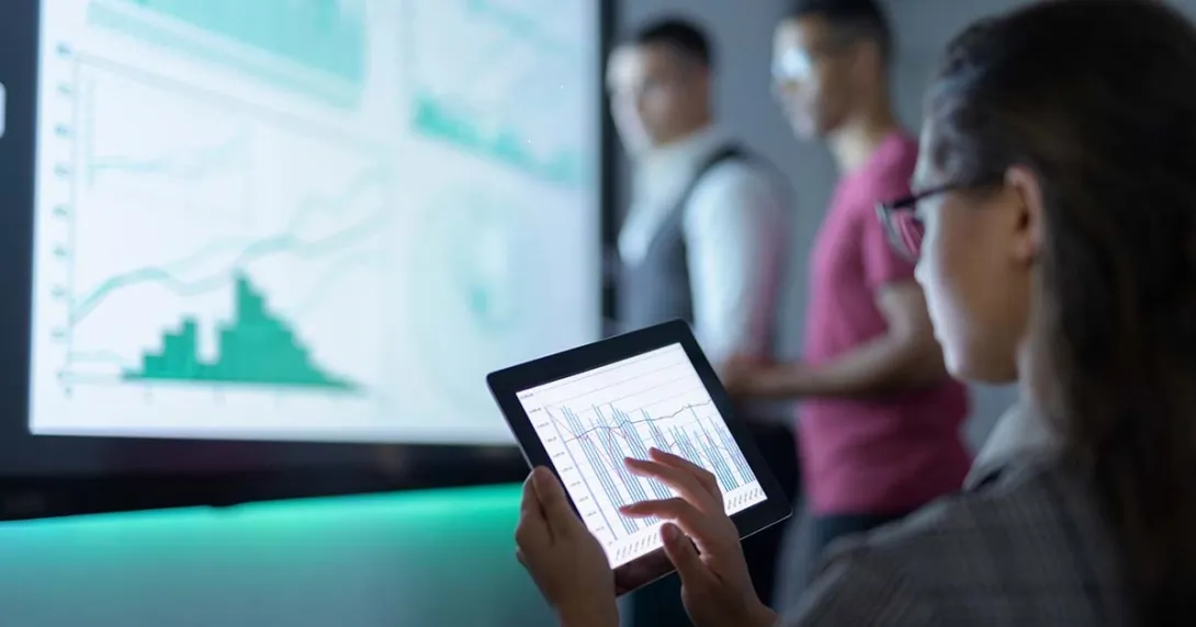 Businessperson viewing graphs on a tablet Businessperson viewing graphs on a tablet
