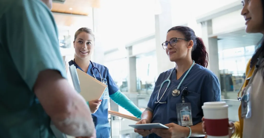 Clinical staff having a conversation in a hallway Clinical staff having a conversation in a hallway