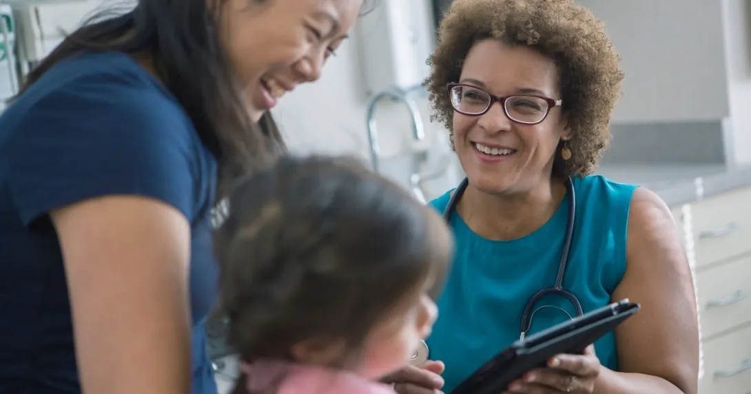 Healthcare worker talking to patient and child Healthcare worker talking to patient and child
