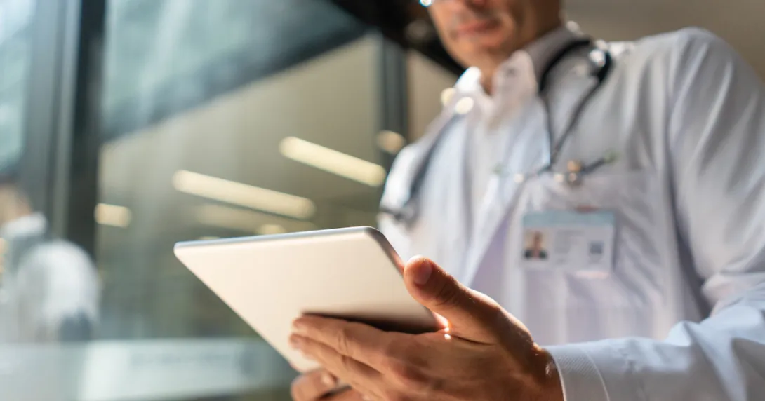 Doctor reviews info on a tablet Doctor reviews info on a tablet
