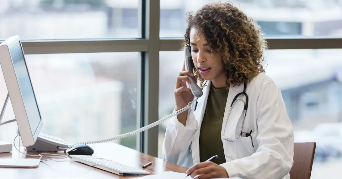 A doctor taking a phone call A doctor taking a phone call