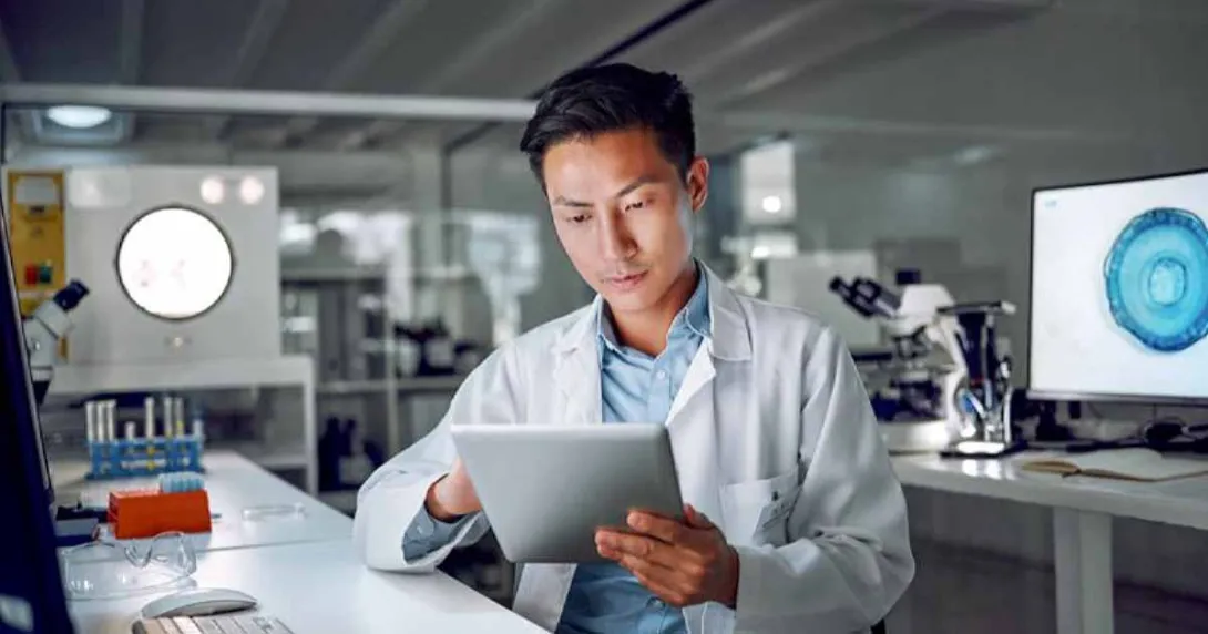 Doctor in lab looking at tablet Doctor in lab looking at tablet