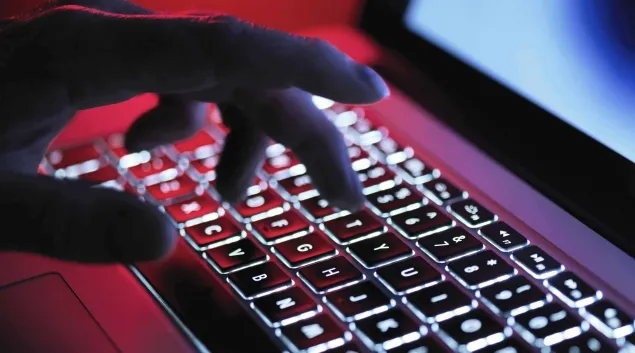 Hand typing on backlit keyboard