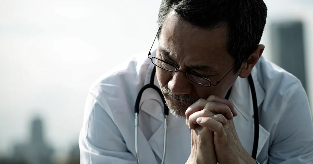 Doctor holding hands together