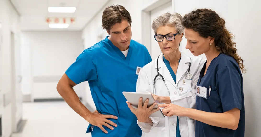 Hospital staff review info on a tablet